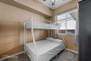 Carpeted bedroom with ceiling fan