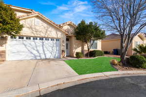 View of front of property with a garage and a front yard