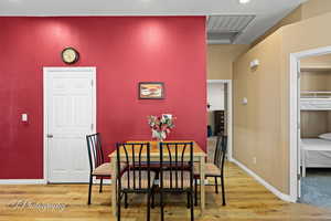 Dining area with wood-type flooring