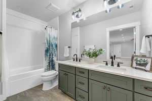 Full bathroom featuring vanity, toilet, and shower / bath combo with shower curtain