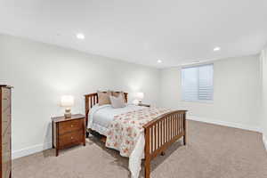 Bedroom with light colored carpet