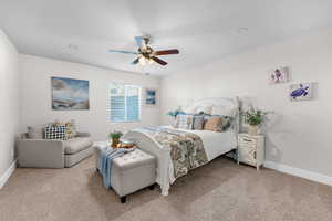 Carpeted bedroom with ceiling fan