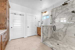 Bathroom with vanity and a shower with shower door