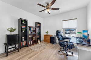 Office space featuring ceiling fan and light wood-type flooring