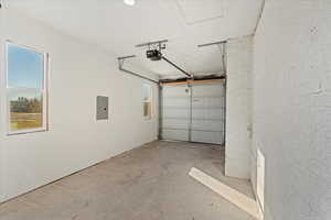 Garage with a garage door opener and electric panel