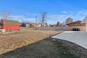 View of yard with a shed and a patio