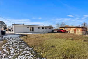 Rear view of property featuring a patio and a lawn