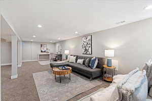 Living room with light carpet and a textured ceiling