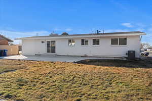 Rear view of house featuring cooling unit, a yard, and a patio area