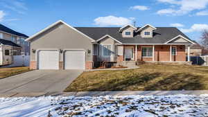 View of front of home featuring a garage and a yard