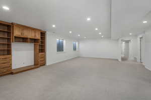 Unfurnished living room featuring light colored carpet