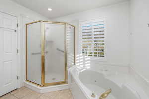 Bathroom with plus walk in shower, tile patterned flooring, and a wealth of natural light