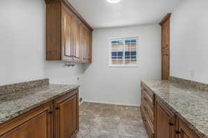 Laundry area with cabinets, hookup for a washing machine, and a textured ceiling