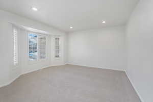 Unfurnished room with light colored carpet