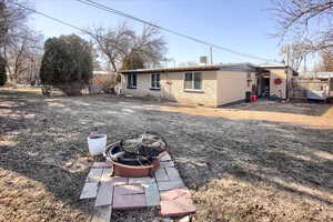 Rear view of house featuring an outdoor fire pit