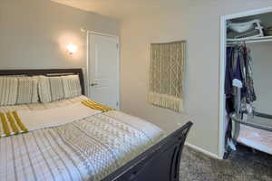 Bedroom with carpet and a closet