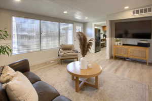 Living room with light hardwood / wood-style floors