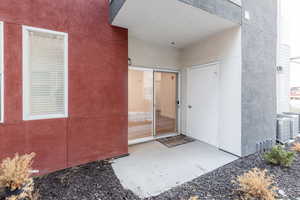 Doorway to property with a patio area