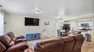 Open concept living room featuring light hardwood / wood-style floors.