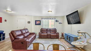 Living room with light hardwood / wood-style flooring