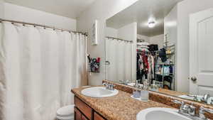 Master bathroom with double sink and walk in closet.