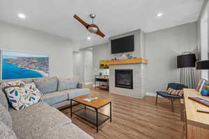 Living room featuring hardwood / wood-style flooring and a tiled fireplace