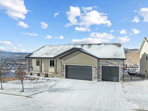 View of front facade with a garage and a mountain view