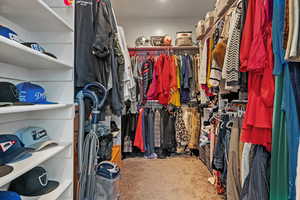 Walk in closet featuring carpet flooring