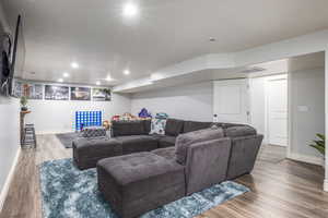 Living room with hardwood / wood-style flooring and a textured ceiling