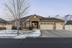 View of front facade featuring a garage and a mountain view