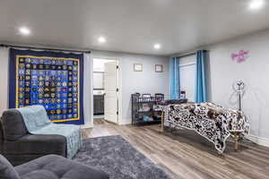 Bedroom with ensuite bath and light hardwood / wood-style floors