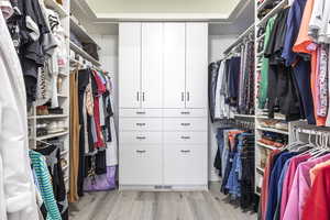 Walk in closet featuring light hardwood / wood-style flooring