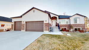 View of front of property with a garage and a front yard