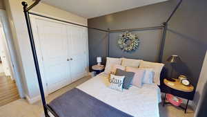 Carpeted bedroom featuring a closet and a textured ceiling