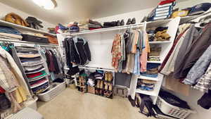 Walk in closet with carpet flooring