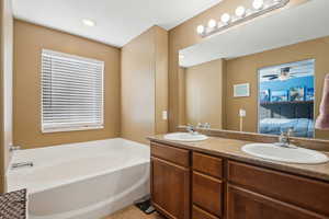 Primary bathroom featuring double sinks and soaking tub