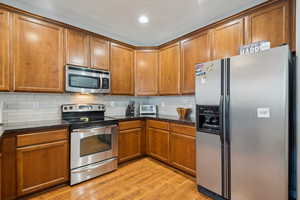 Kitchen featuring light tile backsplash. All appliances included.