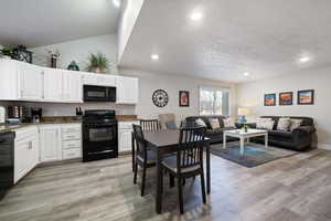 Dining room featuring a textured ceiling and light hardwood / wood-style flooring