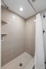 Bathroom featuring curtained shower