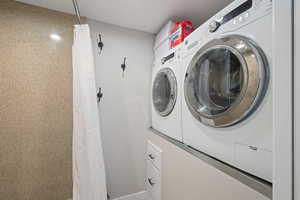 Clothes washing area featuring washer and dryer