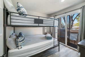 Bedroom with hardwood / wood-style flooring and a textured ceiling