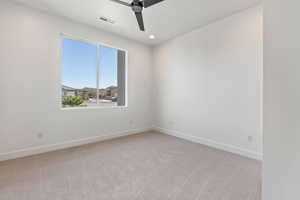 Carpeted spare room with ceiling fan