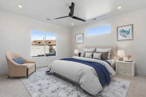 Bedroom featuring light colored carpet and ceiling fan