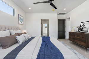 Bedroom with ceiling fan and light colored carpet