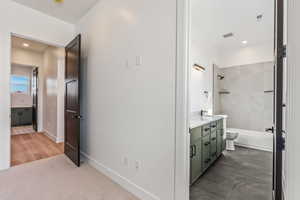 Full bathroom with vanity, toilet, and tiled shower / bath