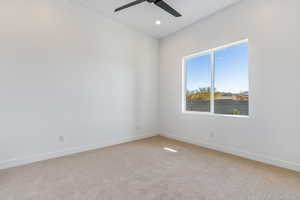 Spare room featuring carpet floors and ceiling fan