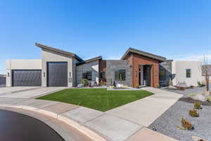 Contemporary home featuring a garage and a front yard