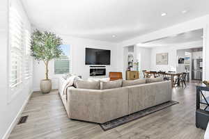 Living room with light hardwood / wood-style floors