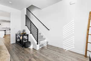 Stairs featuring hardwood / wood-style flooring