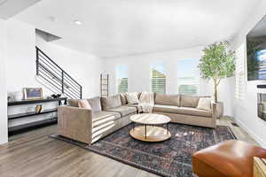 Living room featuring wood-type flooring and a textured ceiling